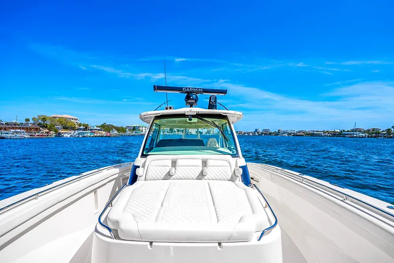 Slide: The Image of 2025 Grady-White Canyon 456 boat on open water under clear blue sky. - 19