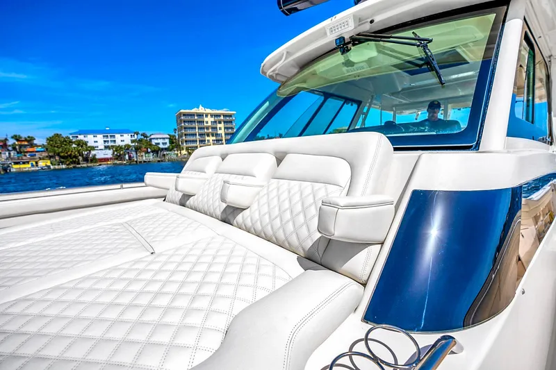 Slide: The Image of 2025 Grady-White Canyon 456 boat with luxurious seating, cruising on a sunny day. - 20