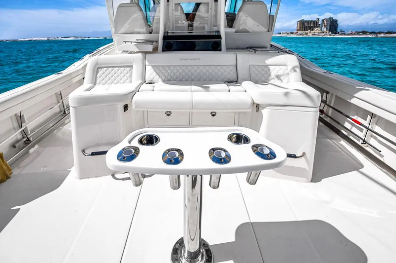 Slide: The Image of 2025 Grady-White Canyon 456 boat interior with luxurious seating and ocean view. - 24