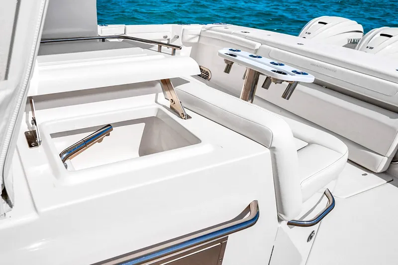 Slide: The Image of 2025 Grady-White Canyon 456 boat interior with fishing rod holders and storage compartment. - 25