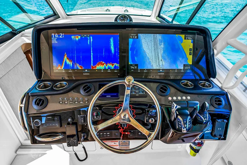 Slide: The Image of Helm of 2025 Grady-White Canyon 456 with advanced navigation displays and controls. - 29