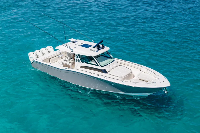 Slide: The Image of 2025 Grady-White Canyon 456 boat cruising on clear blue water. - 3