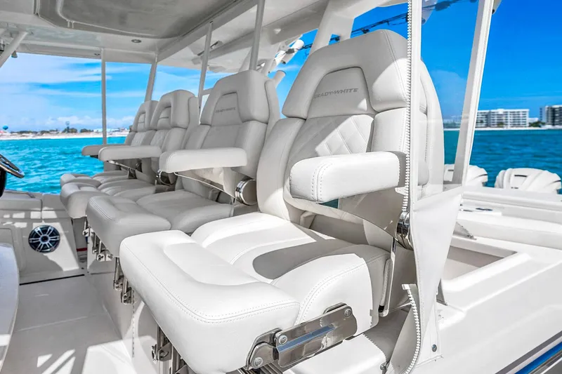 Slide: The Image of Luxurious seating on the 2025 Grady-White Canyon 456 boat, with ocean view in the background. - 31
