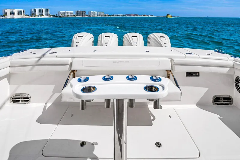 Slide: The Image of 2025 Grady-White Canyon 456 boat with triple V8 engines on open water. - 32