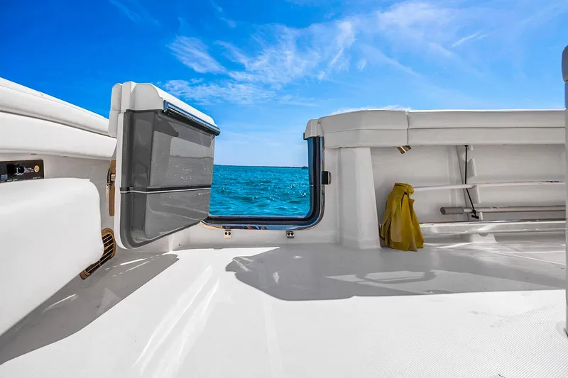 Slide: The Image of 2025 Grady-White Canyon 456 boat deck with ocean view under clear blue sky. - 33