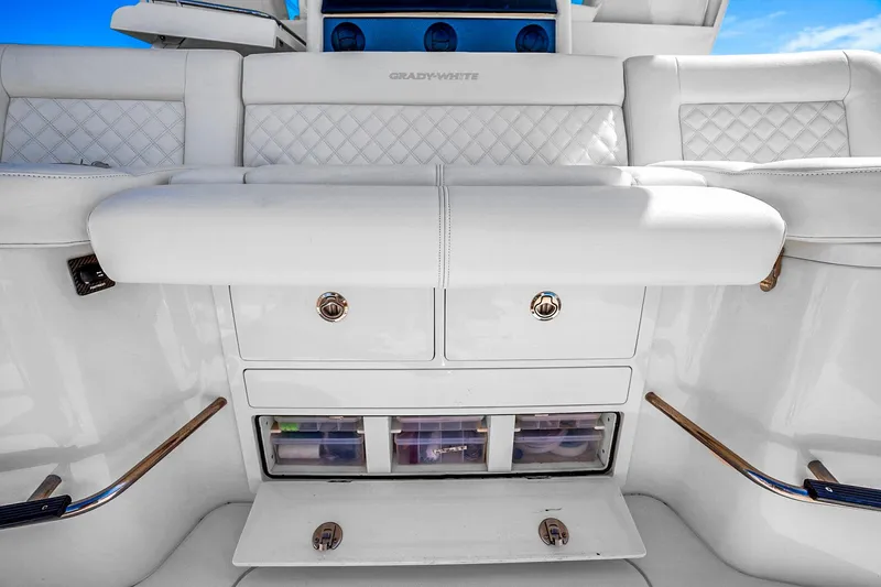 Slide: The Image of 2025 Grady-White Canyon 456 boat interior with white seating and storage compartments. - 37