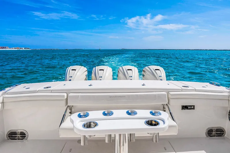 Slide: The Image of 2025 Grady-White Canyon 456 boat with four engines cruising on blue ocean waters. - 43