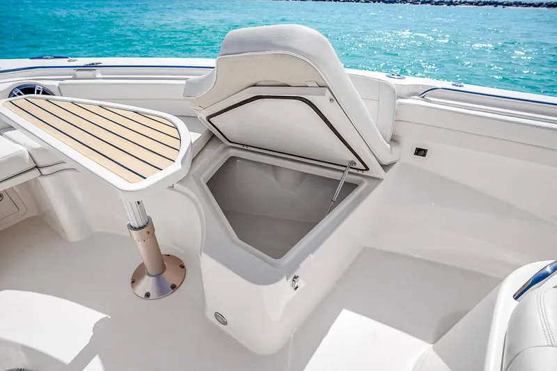 Slide: The Image of 2025 Grady-White Canyon 456 boat interior with open storage and table, ocean view. - 44