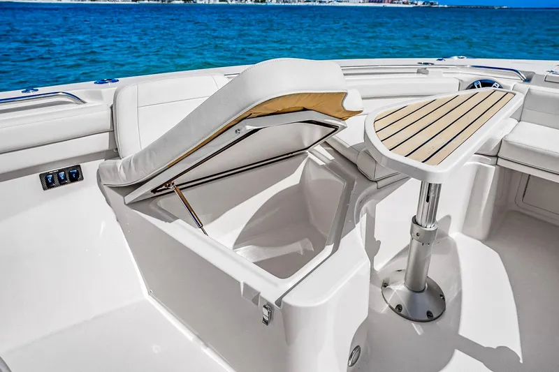 Slide: The Image of 2025 Grady-White Canyon 456 boat interior with seating and table, ocean view. - 45