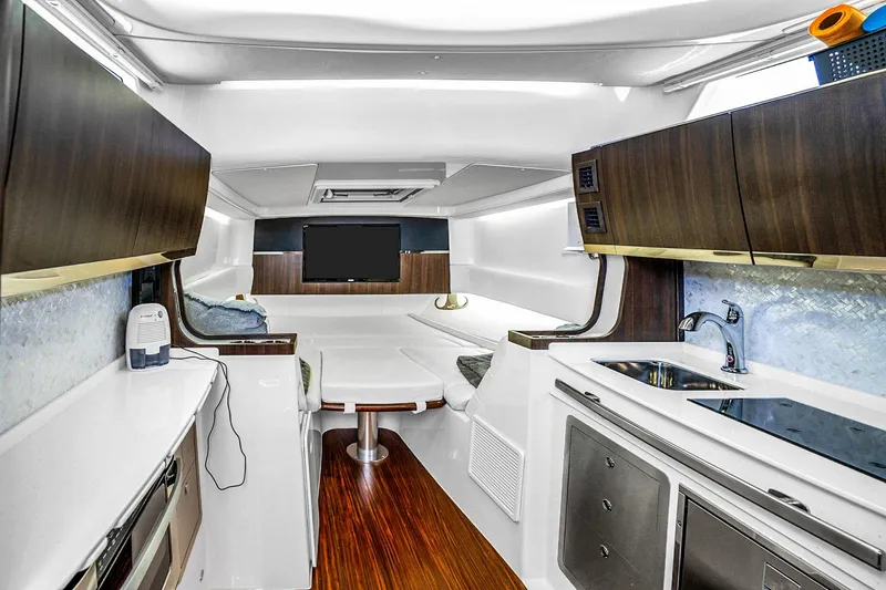 Slide: The Image of Luxurious interior of 2025 Grady-White Canyon 456 boat with modern kitchen and seating area. - 46