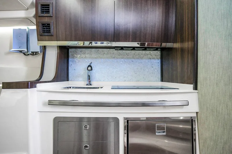 Slide: The Image of Modern kitchenette in 2025 Grady-White Canyon 456 boat with sleek cabinetry and appliances. - 55