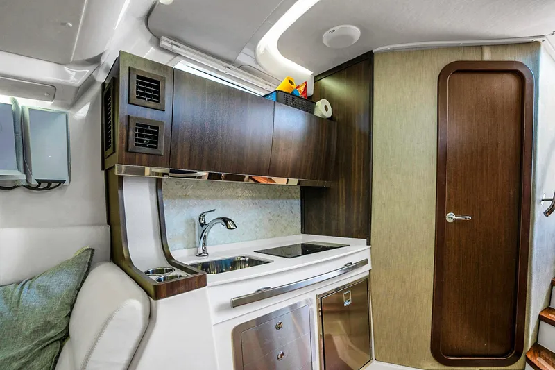 Slide: The Image of Luxurious interior of 2025 Grady-White Canyon 456 boat featuring modern kitchenette design. - 56