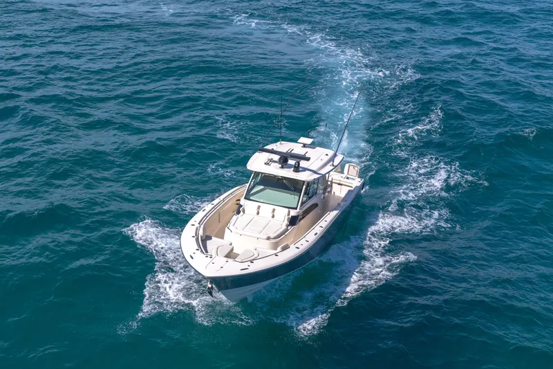 Slide: The Image of 2025 Grady-White Canyon 456 boat cruising on open blue ocean waters. - 6