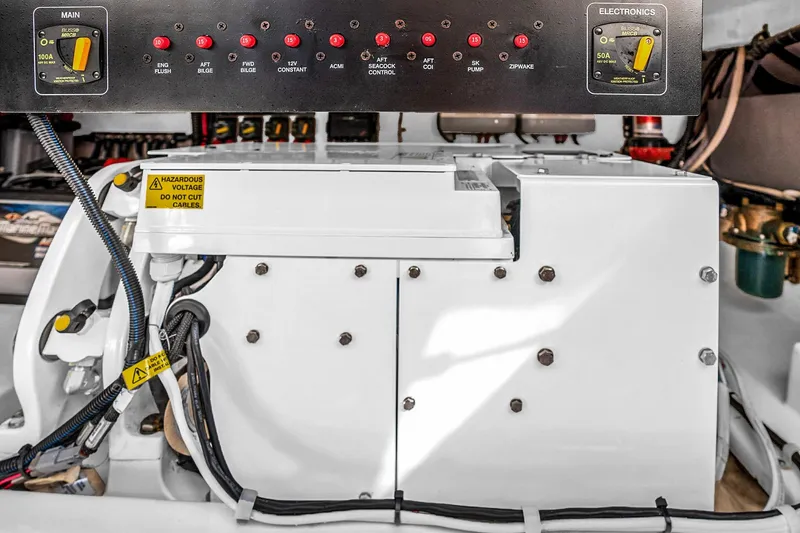 Slide: The Image of Electrical panel and components in a 2025 Grady-White Canyon 456 boat. - 64