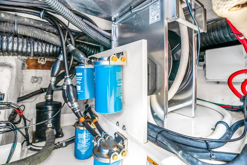 Slide: The Image of Engine compartment of 2025 Grady-White Canyon 456 boat with Yamaha filters and wiring. - 67