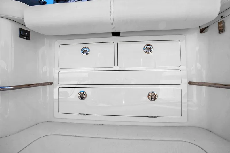 Slide: The Image of 2025 Grady-White Canyon 456 boat storage drawers with sleek white finish and chrome handles. - 69