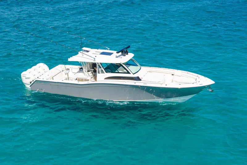 Slide: The Image of 2025 Grady-White Canyon 456 boat cruising on clear blue water. - 8