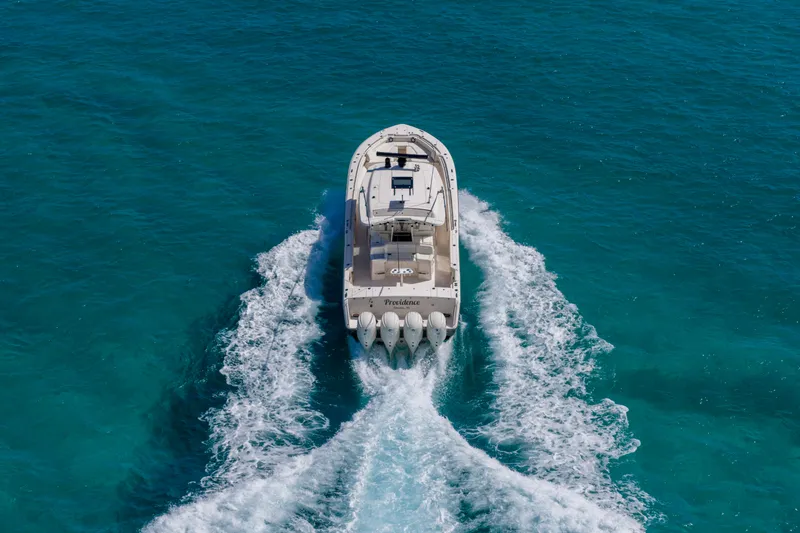 Slide: The Image of 2025 Grady-White Canyon 456 cruising on clear blue ocean waters. - 9