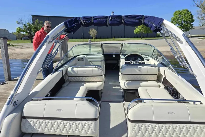 Slide: The Image of 2021 Regal 2800 Bowrider boat with luxurious seating and sleek design at a dock. - 10