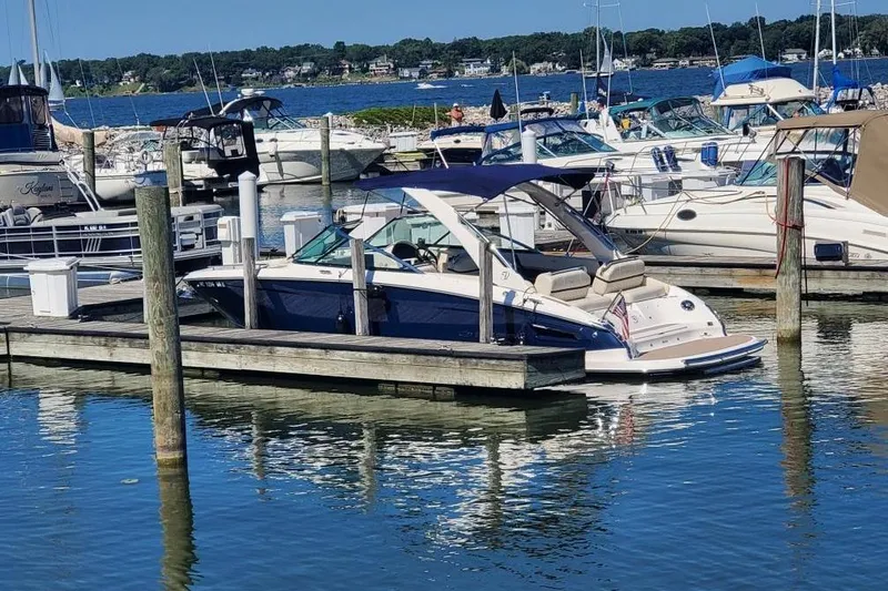 Slide: The Image of 2021 Regal 2800 Bowrider docked at a marina with other boats. - 3