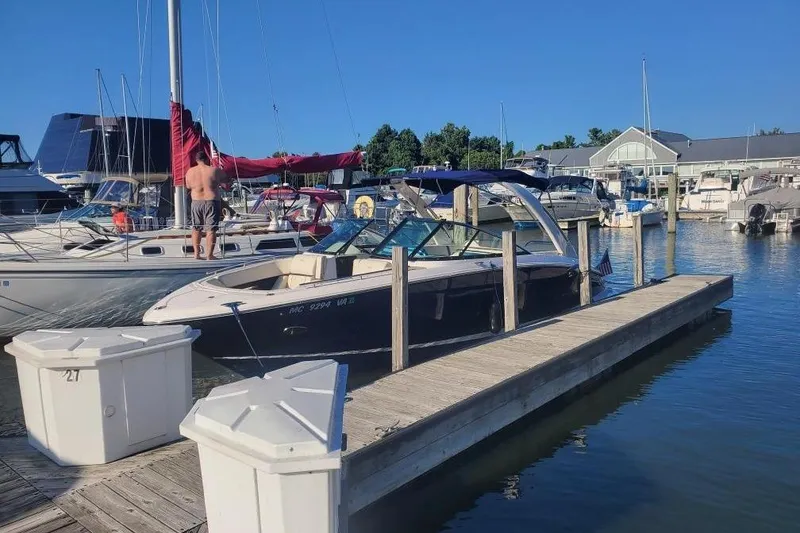 Slide: The Image of 2021 Regal 2800 Bowrider docked at marina on a sunny day. - 4