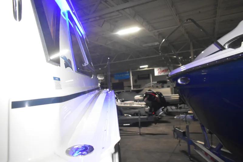 Slide: The Image of 2026 Cutwater C-248 Coupe in a showroom, illuminated by blue lights. - 12