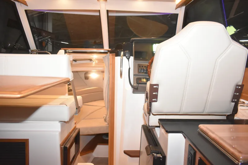 Slide: The Image of Interior of 2026 Cutwater C-248 Coupe, featuring helm and seating area. - 18