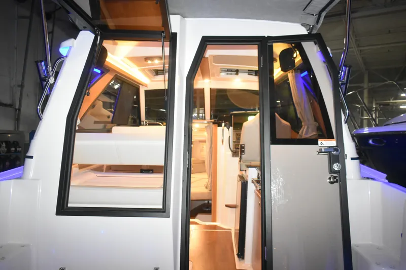 Slide: The Image of 2026 Cutwater C-248 Coupe interior view with illuminated cabin and modern design. - 19