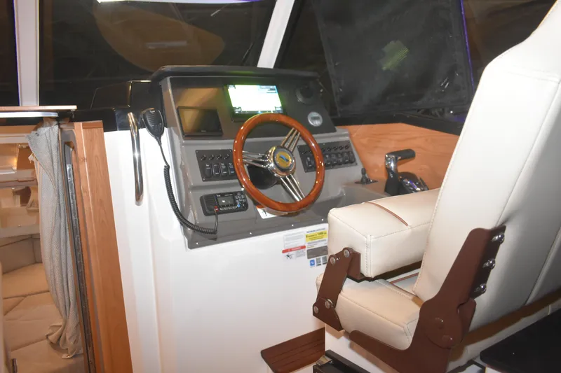 Slide: The Image of 2026 Cutwater C-248 Coupe helm with modern controls and comfortable captain's chair. - 23