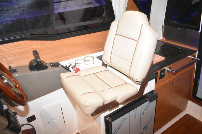 Slide: The Image of Interior of 2026 Cutwater C-248 Coupe featuring helm seat and control panel. - 24