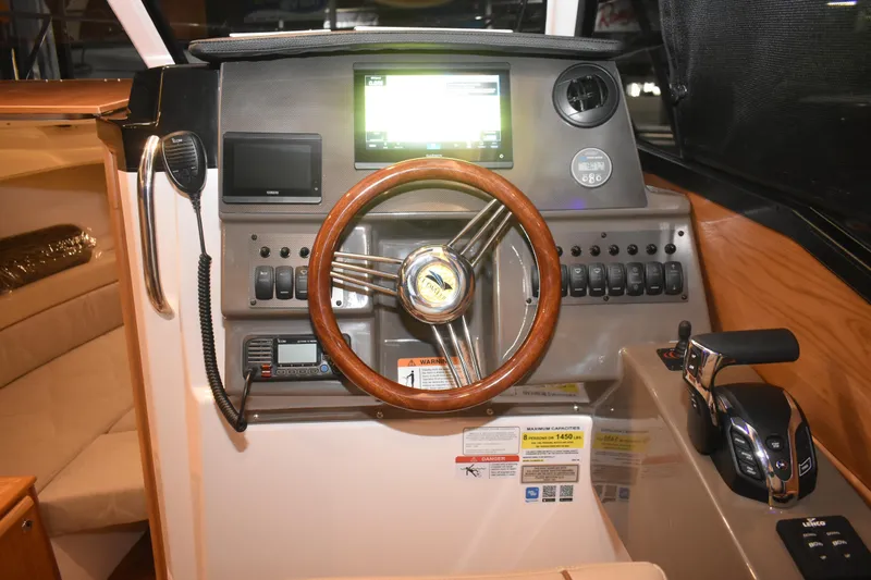 Slide: The Image of 2026 Cutwater C-248 Coupe helm with wood steering wheel and modern controls. - 25