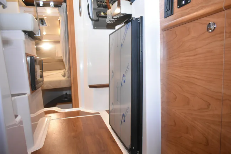 Slide: The Image of Interior of 2026 Cutwater C-248 Coupe, featuring wood accents and modern amenities. - 28