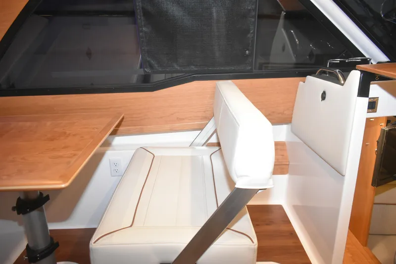 Slide: The Image of Interior of 2026 Cutwater C-248 Coupe featuring a modern seating area and wooden table. - 34