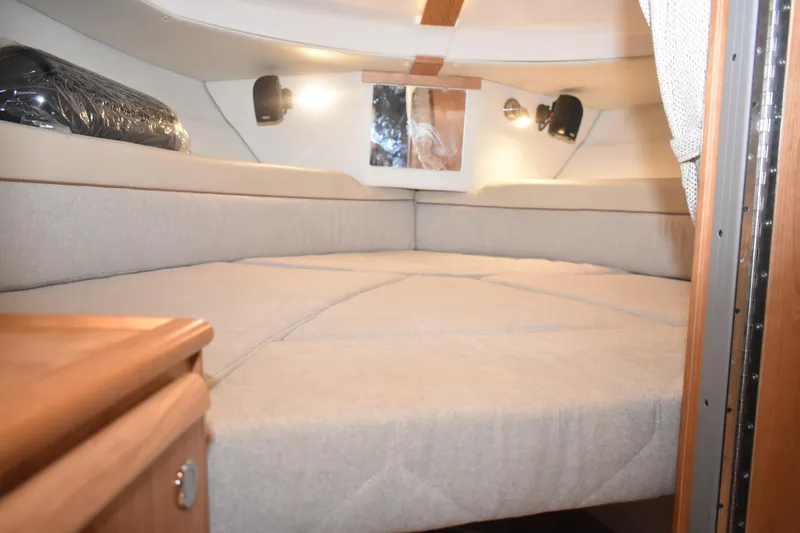 Slide: The Image of Interior cabin of 2026 Cutwater C-248 Coupe with cozy bedding and ambient lighting. - 38