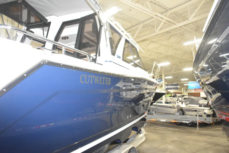 Slide: The Image of 2026 Cutwater C-248 Coupe boat displayed indoors, showcasing sleek blue design. - 4