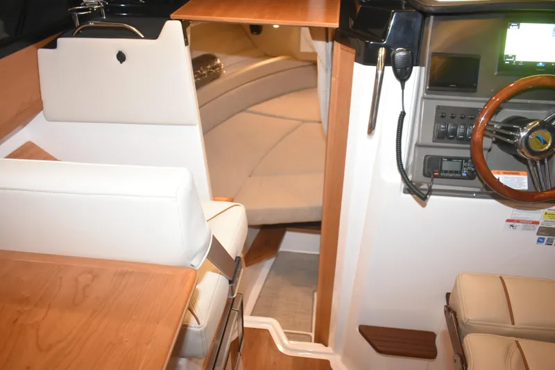 Slide: The Image of 2026 Cutwater C-248 Coupe interior with helm, seating, and cabin view. - 40