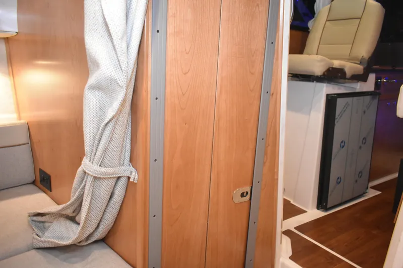 Slide: The Image of 2026 Cutwater C-248 Coupe interior with wooden paneling and seating area. - 43