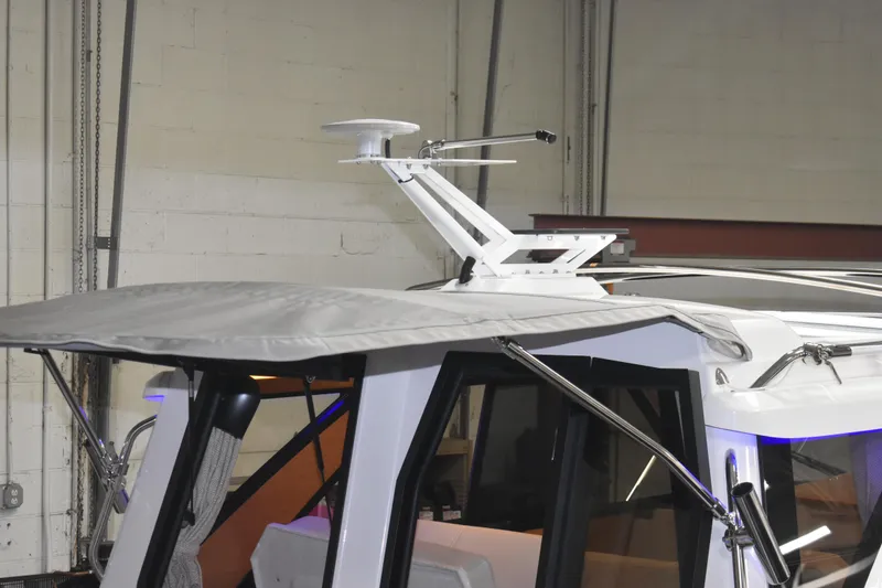 Slide: The Image of 2026 Cutwater C-248 Coupe boat roof with radar and canopy in a garage setting. - 5