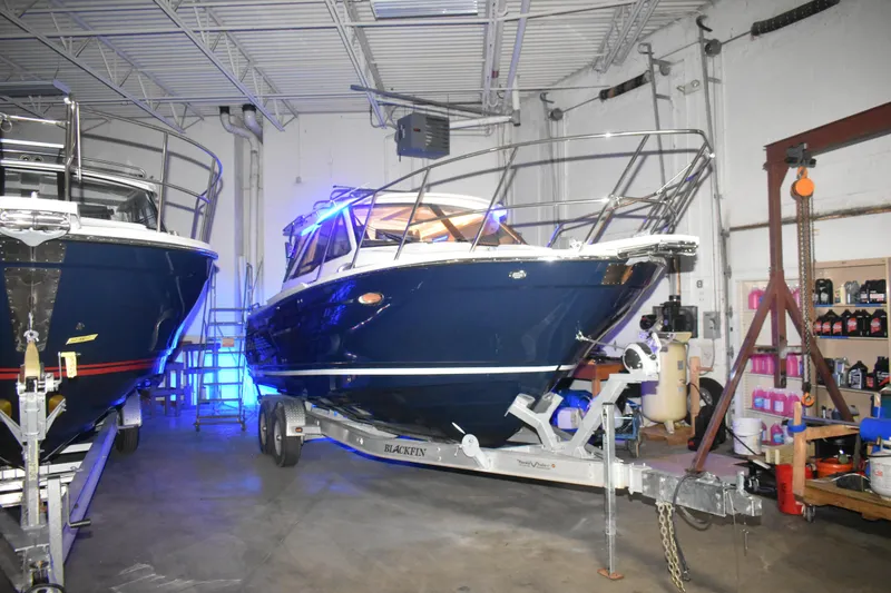 Slide: The Image of 2026 Cutwater C-248 Coupe boat on trailer in indoor storage facility. - 6