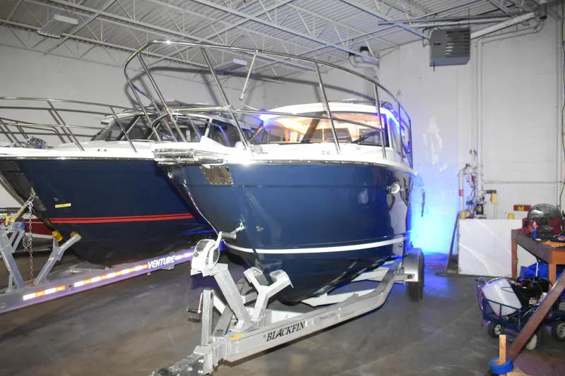 Slide: The Image of 2026 Cutwater C-248 Coupe boat in a garage on a trailer. - 7