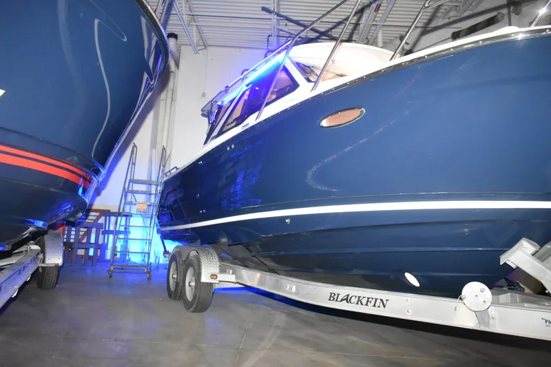 Slide: The Image of 2026 Cutwater C-248 Coupe boat on trailer in indoor storage facility. - 8