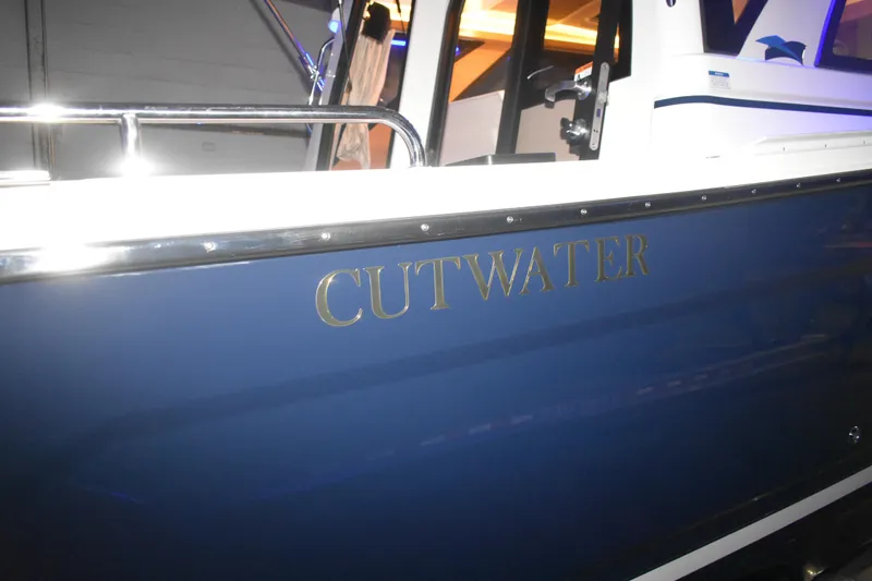Slide: The Image of 2026 Cutwater C-248 Coupe boat with blue hull and chrome lettering. - 9