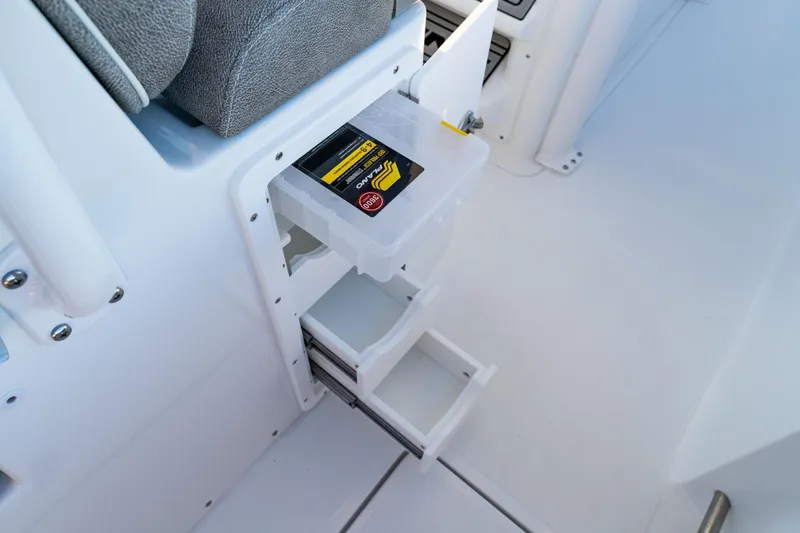 Slide: The Image of Storage compartment on 2026 Sea Hunt Ultra 275 Coffin Box boat, featuring organized drawers. - 16
