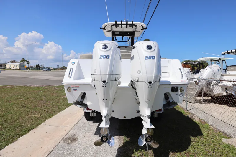 Slide: The Image of 2026 Sea Hunt Ultra 275 Coffin Box with dual 200 horsepower engines, parked outdoors. - 17