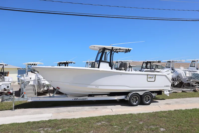 Slide: The Image of 2026 Sea Hunt Ultra 275 Coffin Box boat on trailer, parked outdoors. - 19