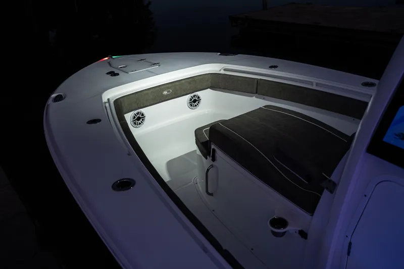 Slide: The Image of 2026 Sea Hunt Ultra 275 Coffin Box boat interior with cushioned seating and speakers. - 28