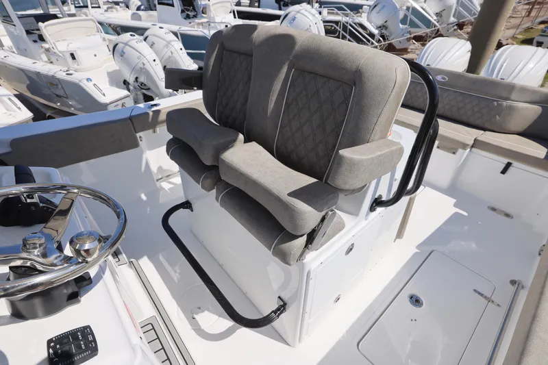 Slide: The Image of 2026 Sea Hunt Ultra 275 Coffin Box boat with dual cushioned seats and steering wheel. - 5