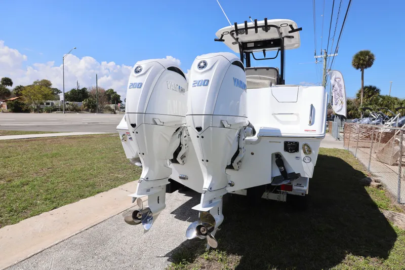 Slide: The Image of 2026 Sea Hunt Ultra 275 Coffin Box with dual Yamaha 200 engines, parked outdoors. - 8