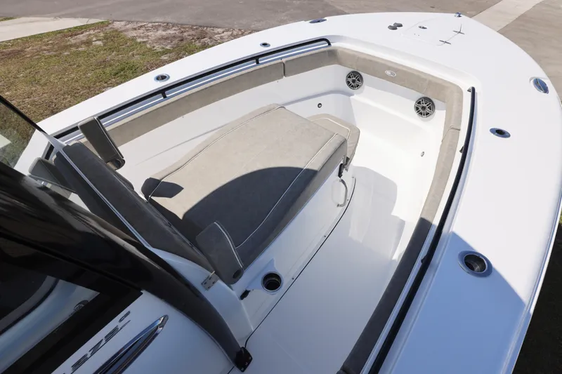 Slide: The Image of 2026 Sea Hunt Ultra 275 Coffin Box boat interior with cushioned seating and speakers. - 9