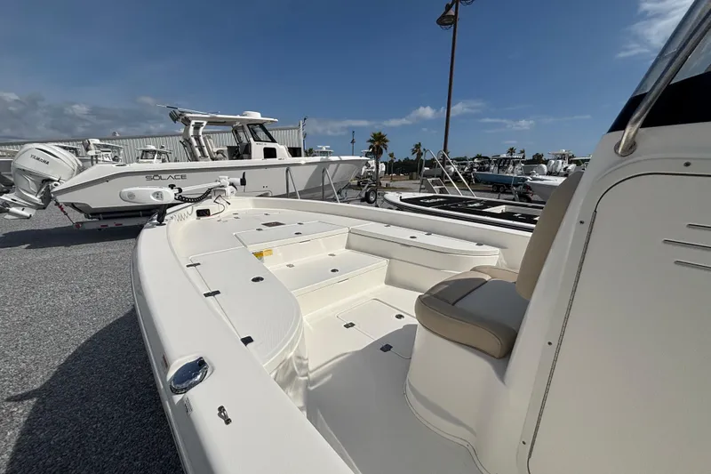 Slide: The Image of 2018 NauticStar 244 XTS boat displayed in a marina under a clear blue sky. - 3